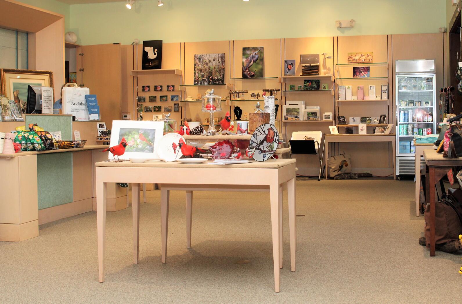Store interior with a large table and merchandise.